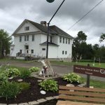 dog sniffs happily by a model of the planet Uranus, part of the Maine Solar System